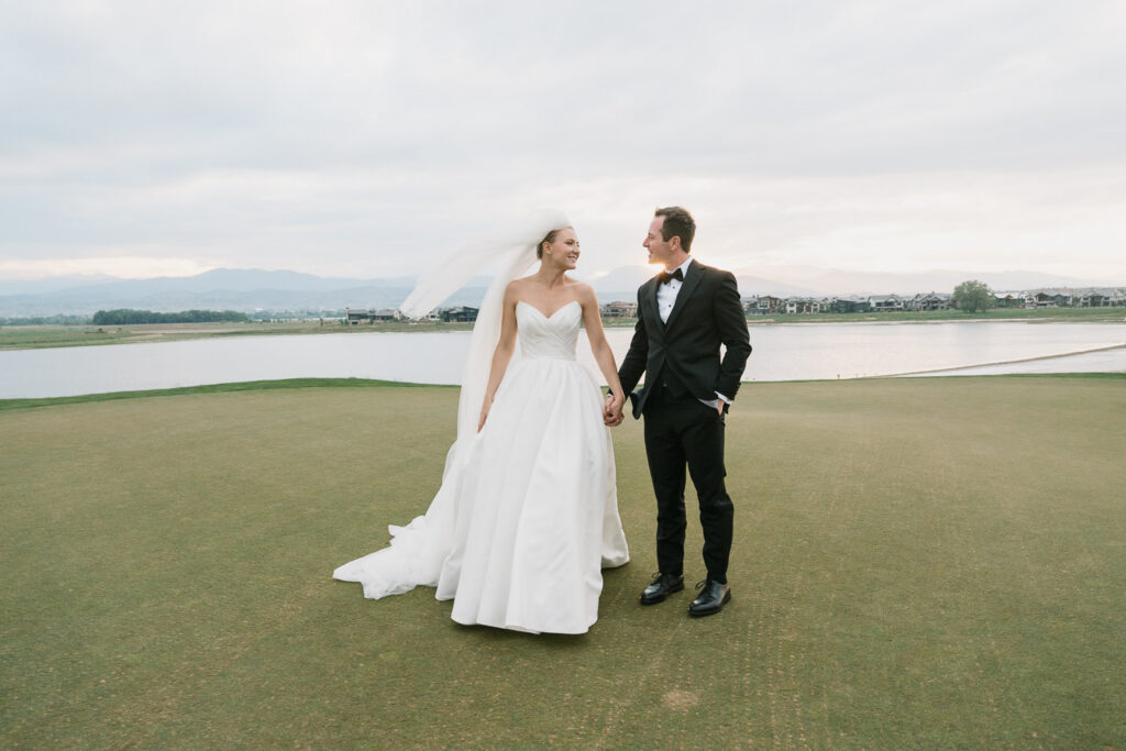 a bride and groom take sunset portraits during their TPC Colorado wedding