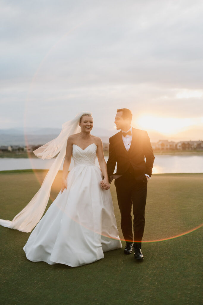 a bride and groom take sunset portraits during their TPC Colorado wedding