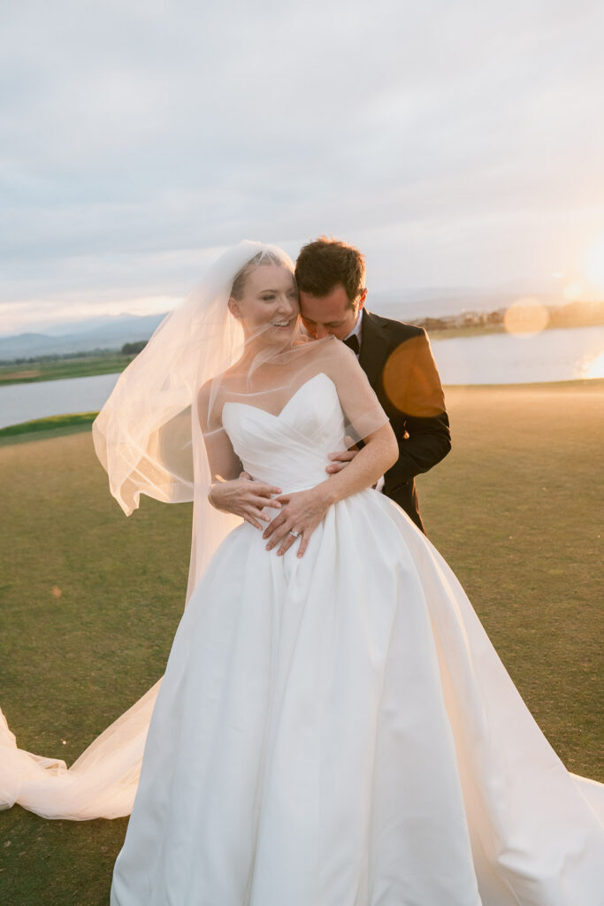 a bride and groom take sunset portraits during their TPC Colorado wedding