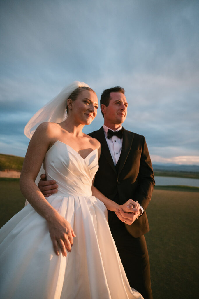 a bride and groom take sunset portraits during their TPC Colorado wedding