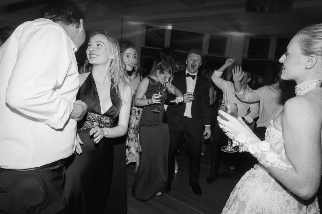 guests dance the night away at a a bride and groom take sunset portraits during their TPC Colorado wedding
