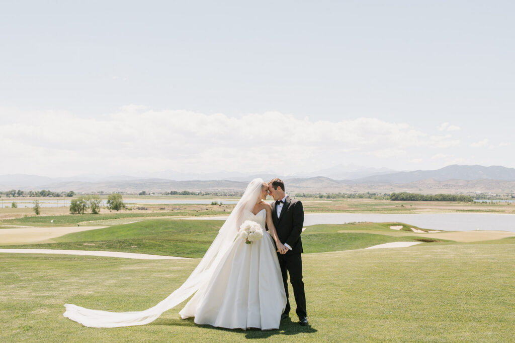a bride and groom take portraits on the golf course before their TPC Colorado wedding
